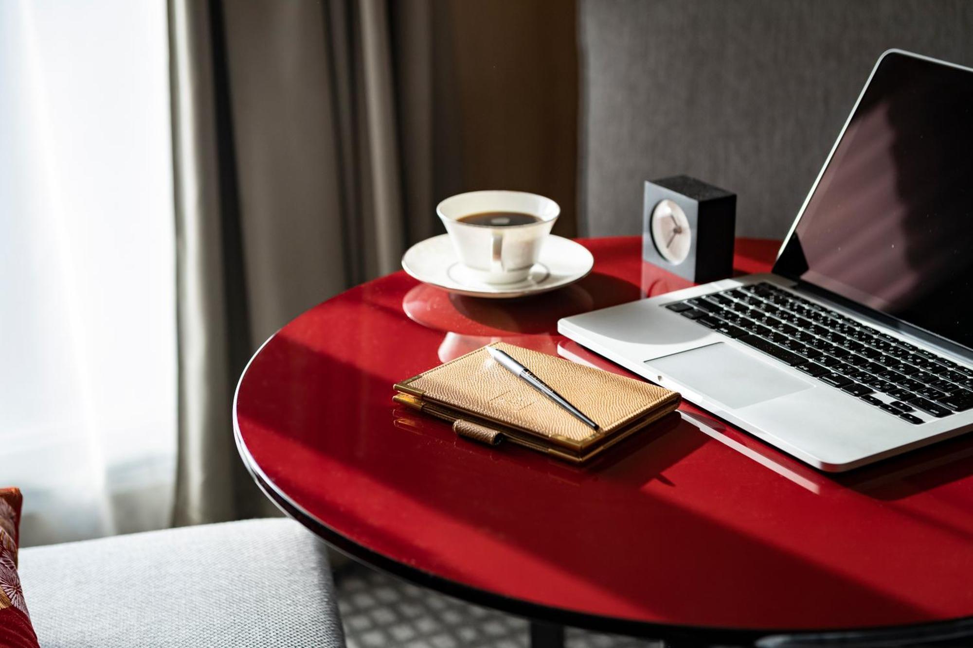 Kyoto Tokyu Hotel Zewnętrze zdjęcie A table with a laptop, a cup of coffee, a notebook and a pen